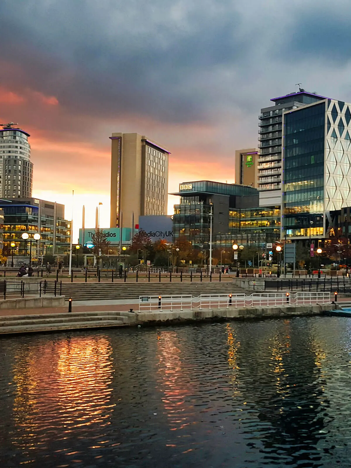 An On Thyme Logistics vehicle operating near Salford Quays at sunset, ensuring temperature-controlled deliveries across Greater Manchester.